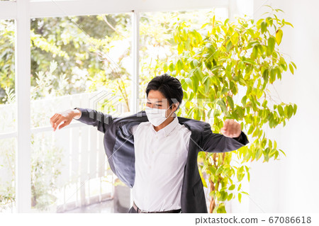 A young man wearing a mask (wearing and undressing) A young man wearing a mask (wearing and undressing) 67086618