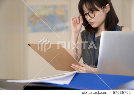 Young woman working in the office Young woman working in the office 67086703