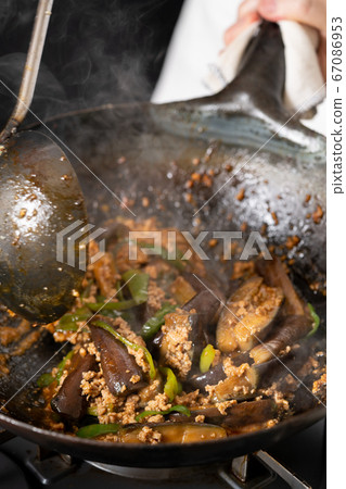 Fry the mapo eggplant in a wok Fry the mapo eggplant in a wok 67086953