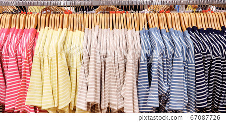 Multi-colored striped T-shirts on hangers Multi-colored striped T-shirts on hangers 67087726