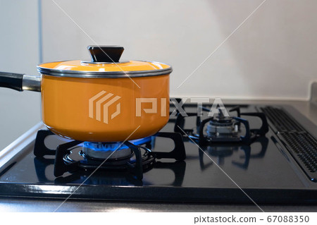 Cooking pot on the gas stove in the kitchen Cooking pot on the gas stove in the kitchen 67088350