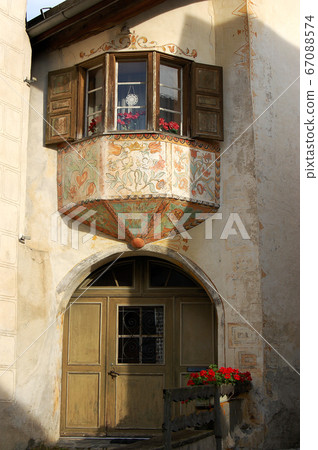 Ancient balcony with wooden windows - Guarda village Engadine Switzerland 67088574