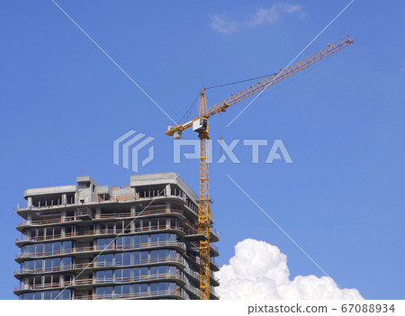 A crane on the construction of a new house. A crane on the construction of a new house. 67088934