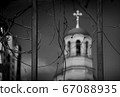 View of the temple through the bars and branches 67088935