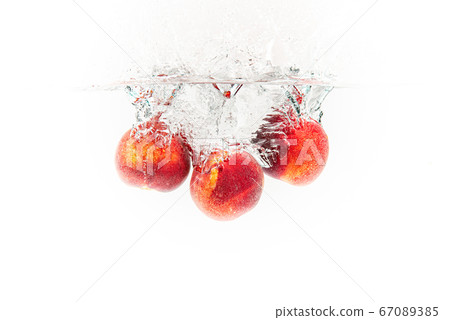 Fresh Nectarines with water splash against white Fresh Nectarines with water splash against white 67089385