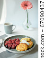 Homemade baked cheesecake on a gray clay plate. Pie with raspberries in small portions, white background 67090437