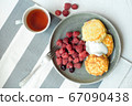 Homemade baked cheesecake on a gray clay plate. Pie with raspberries in small portions, white background 67090438