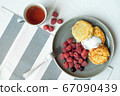 Homemade baked cheesecake on a gray clay plate. Pie with raspberries in small portions, white background 67090439