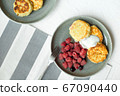 Homemade baked cheesecake on a gray clay plate. Pie with raspberries in small portions, white background 67090440