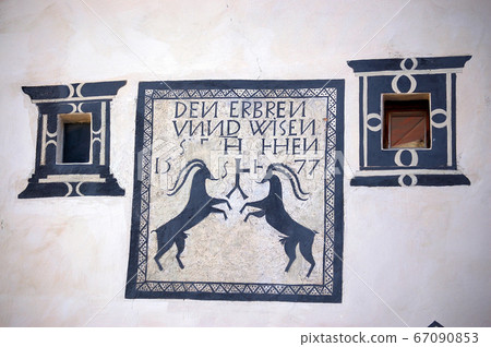 Two small windows with frescoes - Guarda village Engadine Switzerland 67090853