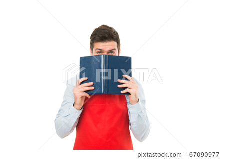 What to cook. Man hipster cook apron reading book What to cook. Man hipster cook apron reading book 67090977