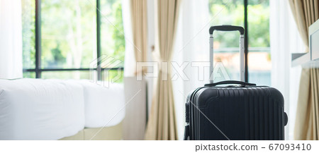 Black Luggage in modern hotel room with windows, 67093410