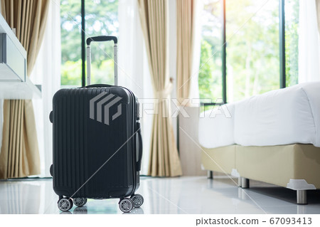 Black Luggage in modern hotel room with windows, 67093413