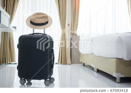Black Luggage and hat in modern hotel room with 67093418