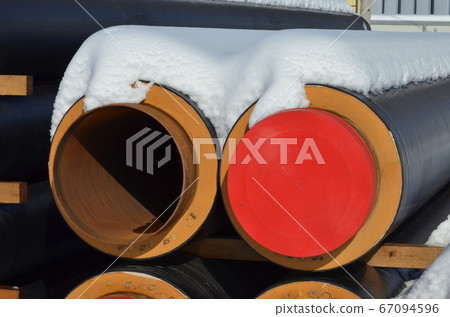 Construction Materials. Industrial pipes under snow. 67094596