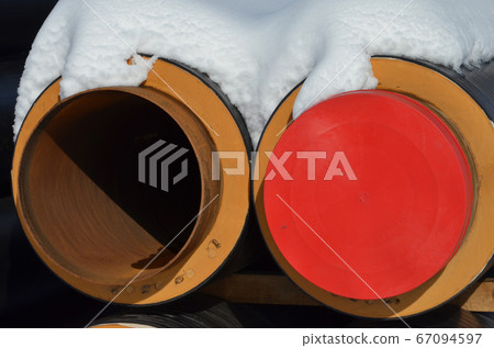 Construction Materials. Industrial pipes under snow. Construction Materials. Industrial pipes under snow. 67094597