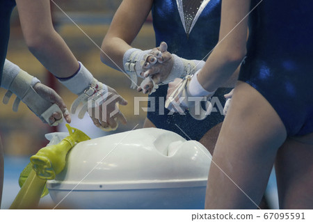 Female hands gymnasts clapping white chalk powder at the championship Female hands gymnasts clapping white chalk powder at the championship 67095591