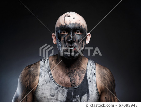 Photo of bald mad man with black goo in the mouth Photo of bald mad man with black goo in the mouth 67095945