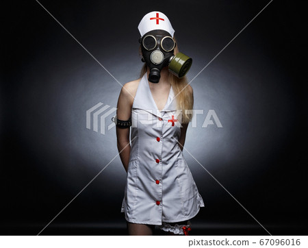 Image of young nurse in gas mask 67096016