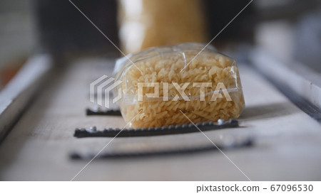 Food industry - conveyor with plastic pack of macaroni Food industry - conveyor with plastic pack of macaroni 67096530
