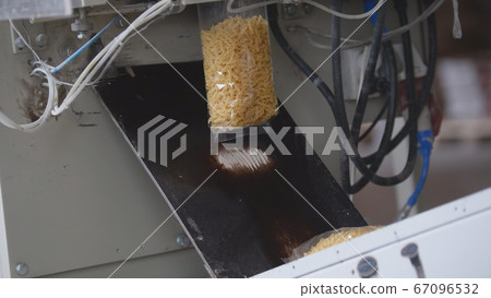Food manufacturing - packing of macaroni in plastic bags Food manufacturing - packing of macaroni in plastic bags 67096532
