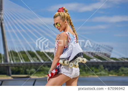 girl in an American T-shirt with roller skates girl in an American T-shirt with roller skates 67096942