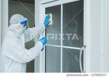 Staff is spraying disinfectant and wiping clean Staff is spraying disinfectant and wiping clean 67098537