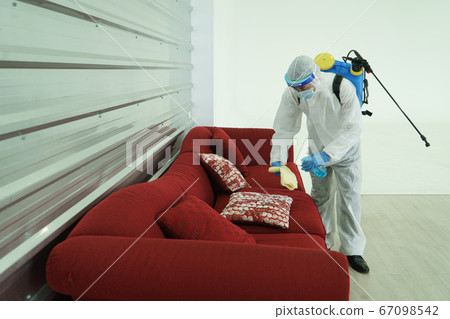 Staff is spraying disinfectant and wiping clean Staff is spraying disinfectant and wiping clean 67098542