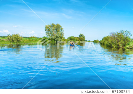 Couple at kayak trip on blue river landscape Couple at kayak trip on blue river landscape 67100784