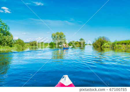 Kayak trip on blue river landscape Kayak trip on blue river landscape 67100785
