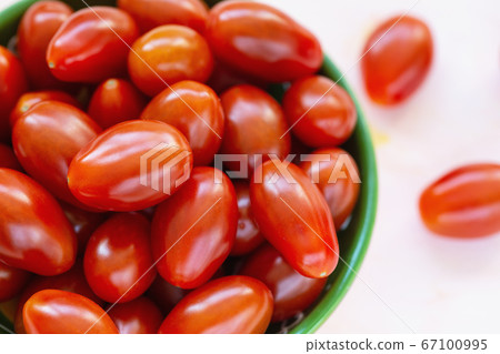 Fresh red cherry tomatoes on light background Fresh red cherry tomatoes on light background 67100995