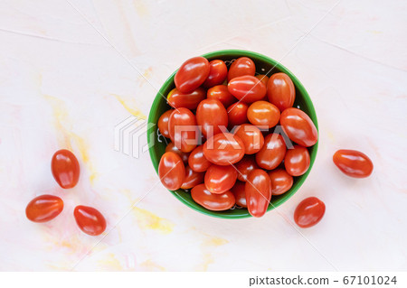 Fresh red cherry tomatoes on light background Fresh red cherry tomatoes on light background 67101024