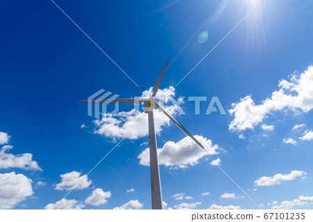 Wind turbines for power generation on hill against blue sky 67101235
