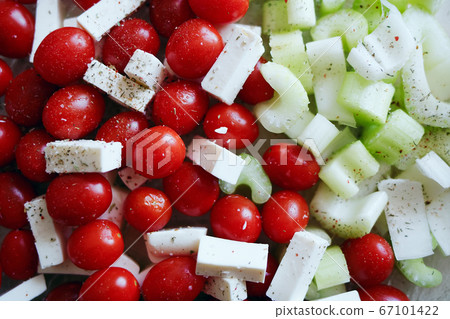 A simple salad for a healthy diet. Cherry tomatoes, celery and slices of cheese. Fresh vegetables A simple salad for a healthy diet. Cherry tomatoes, celery and slices of cheese. Fresh vegetables 67101422