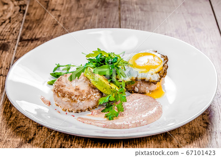 A plate of crab cutlets on a table 67101423