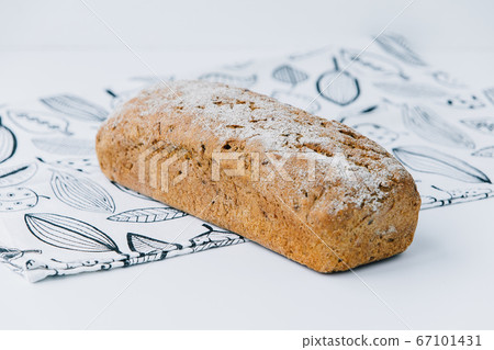 A piece of Cereal loaf on a plate A piece of Cereal loaf on a plate 67101431