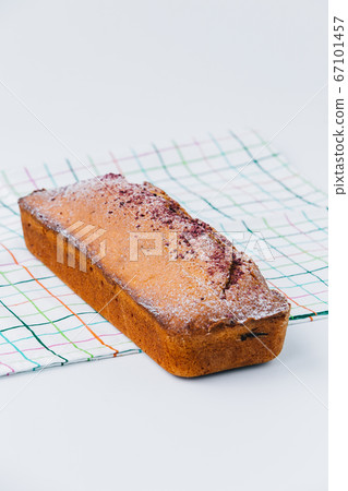 A piece of cinnamon cupcake sitting on top of a table A piece of cinnamon cupcake sitting on top of a table 67101457