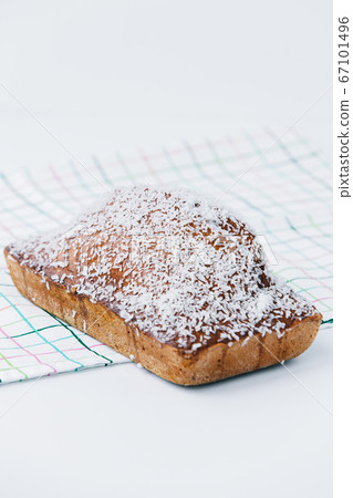 A piece of cake with coconut and malibu syrup on a plate A piece of cake with coconut and malibu syrup on a plate 67101496