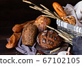 Concept of homemade bread, natural farm products, domestic production. Healthy and tasty organic food. Close up, dark black background 67102105