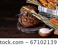 Concept of homemade bread, natural farm products, domestic production. Healthy and tasty organic food. Close up, dark black background. Copy space for text 67102139