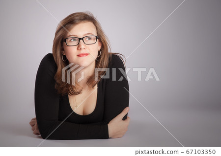 Young woman is laying on the floor 67103350