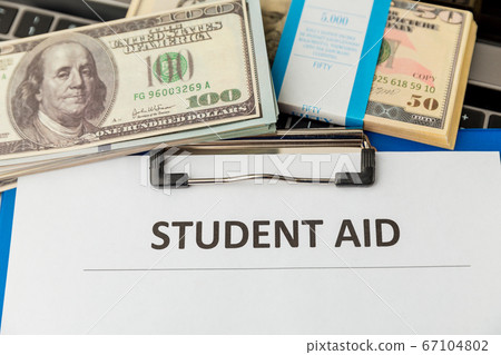 Financial help for student statement. Money on the laptop. Financial help for student statement. Money on the laptop. 67104802