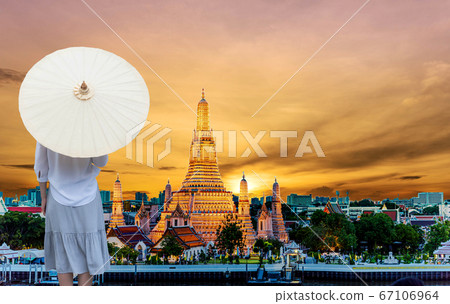 Asian women laying umbrellas in natural scenery, 67106964