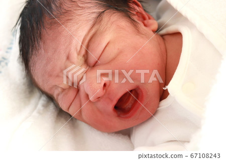 A newborn baby boy who is just born and opens his mouth wide and cries A newborn baby boy who is just born and opens his mouth wide and cries 67108243