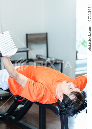 Men using dumbbells in a private gym Men using dumbbells in a private gym 67113484