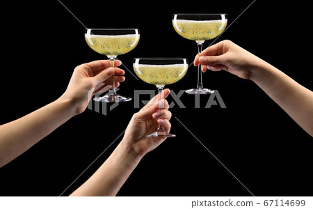 Set of hands holding glass of sparkling champagne isolated on black. Set of hands holding glass of sparkling champagne isolated on black. 67114699