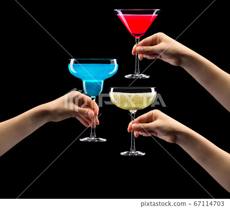 Set of hands holding cocktails isolated on black background 67114703