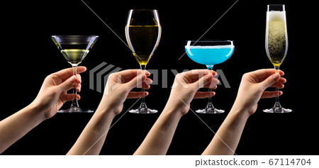 Set of hands holding cocktails isolated on black background 67114704
