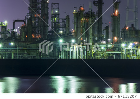 Industrial area at night lined with plant chimneys 67115207