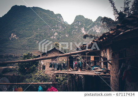 Stilted mud and wood houses of Khuoi Ky rock village built on the karst mountains  in Cao Bang Vietnam shows the old traditions and lifestyle of Vietnamese people 67117434
